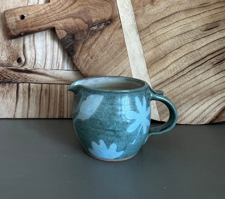 handmade pottery creamer with floral design